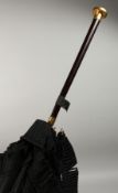 AN EDWARDIAN PARASOL with rosewood handle. 38ins long.