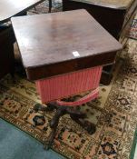 A 19TH CENTURY ROSEWOOD PEDESTAL SEWING TABLE, possibly Isle of Man, on curving pad feet.