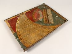 AN EARLY, POSSIBLY 17TH CENTURY PAINTED WOODEN SUNDIAL 15ins x 10.5ins.