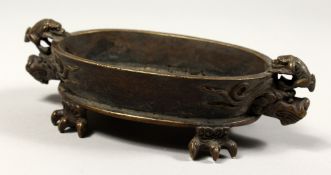A GOOD CHINESE BRONZE CENSER with dragon handles and claw feet, impressed mark. 7.5ins long.
