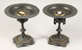 A PAIR OF EGYPTIAN REVIVAL METAL TAZZAS with circular top. 8.5ins high.