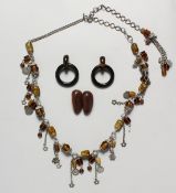 A GOOD MONIES SILVER AND AMBER NECKLACE AND HORN EARRINGS in a black bag.