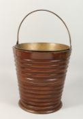 A DUTCH MAHOGANY PEAT BUCKET with brass liner and handles.12ins high.