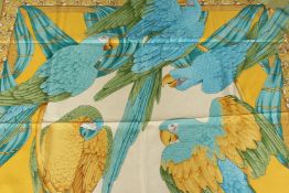 A SALVATORE FERRAGAMO SILK SCARF, yellow, green and blue parrots. 68ins x 36ins.