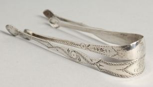 TWO GEORGE III BRIGHT CUT SUGAR TONGS, London 1799, Peter and Rene Babiion and maker I.C.