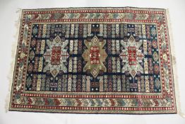 A PERSIAN GREEN GROUND, ARDABIL CARPET, with three large central medallions. 8ft x 5ft 6ins.