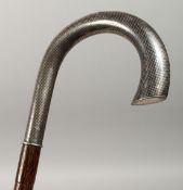 A BAMBOO TYPE WALKING STICK with niello silver handles, 38ins long.