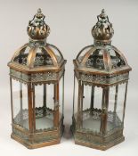 A PAIR OF CIRCULAR METAL AND GLASS LANTERNS, 24ins high.