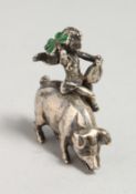 A SMALL SILVER CHERUB, RIDING A PIG, holding a shamrock. Chester 1898.