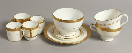 FOUR MINTON COFFEE CUPS, A SAUCER, TWO TEACUPS, ONE WITH A CREST, a sugar bowl and a side plate