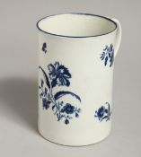 AN 18TH CENTURY TALL CYLINDRICAL MUG, decorated with a large blue flower, scattered floral sprigs