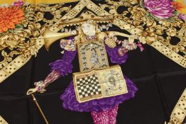 A SALVATORE FERRAGAMO SILK SCARF, multi coloured, yellow ground with dominoes, flowers and cards.