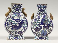 A SMALL PAIR OF CHINESE CLOISONNE MOON VASES, decorated with birds in blue. 3.75ins high.