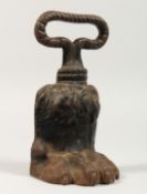 A GEORGIAN CAST IRON PAW DOOR STOP. 7ins.