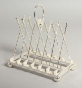 A SILVER PLATED NOVELTY CROSSED GOLF CLUBS TOAST RACK.
