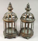 A PAIR OF CIRCULAR METAL AND GLASS LANTERNS, 24ins high.