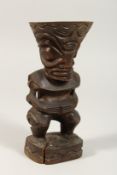 A CARVED WOOD TRIBAL FIGURE TIKI. 8ins high.