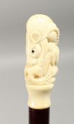 A CARVED BONE HANDLED WALKING STICK, carved with a rat, 35ins long.