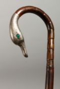A BAMBOO TYPE WALKING STICK with silver duck's head handle and glass eyes. August 1911.