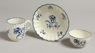 AN 18TH CENTURY WORCESTER COFFEE CUP, TEABOWL AND SAUCER painted with a large trailing flower,