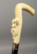 A GOOD 19TH CENTURY AMERICAN WALKING STICK, the ivory handle carved with a dog's head carrying a