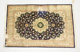 A PERSIAN SILK QUOM RUG, blue ground with all over floral decoration. 4ft 10ins x 3ft 1ins.