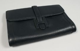 A NAVY LEATHER CLUTCH BAG. 11.5ins x 8ins.