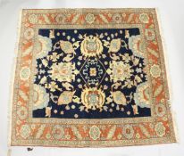A GOOD PERSIAN CARPET, blue ground with stylised decoration, within an orange border. 7ft 6ins x 7ft