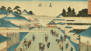 A 19th Century Japanese woodblock, Figures in a street, with script, 7.5