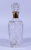A CUT GLASS SQUARE TAPERING DECANTER AND STOPPER with silver band. Birmingham.