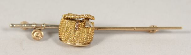 A 9CT GOLD FISHING BASKET AND ROD TIE PIN, cased.