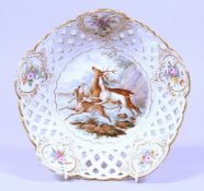 A GOOD MEISSEN PORCELAIN CIRCULAR PIERCED DISH painted with dogs chasing a stag.