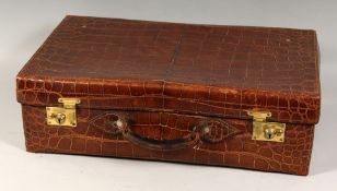 A GENTLEMAN'S ALLIGATOR SUITCASE with brushes etc.. 23ins long x 13ins wide x 7ins deep.