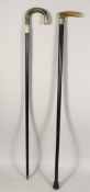TWO HORN HANDLE WALKING STICKS with silver bands 35ins long.