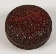A GOOD SMALL 19TH CENTURY CINNABAR LACQUER CIRCULAR BOX AND COVER carved with birds and flowers. 3.