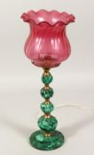 A 19TH CENTURY ONYX LAMP BASE with ruby glass shade. 12ins high.