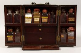 A 19TH CENTURY MAHOGANY APOTHECARY CABINET with folding open doors and fitted interior with
