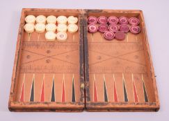 A SET OF TWELVE WHITE AND FOURTEEN RED STAINED IVORY DRAUGHT PIECES, 3cm diameter, in a leather
