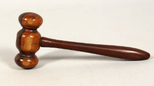 A TURNED WOOD GAVEL 7ins long.