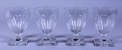 A SET OF FOUR CUT GLASS GOBLETS on square bases.