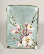 A .935 SILVER AND ENAMEL CIGARETTE CASE the enamel lid with blossom. 3.5ins x 2.5ins