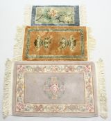 THREE SMALL CHINESE RUGS. 3ft 3ins x 2ft, 2ft 7ins x 1ft 6ins, and 2ft 1in x 1ft 0ins.