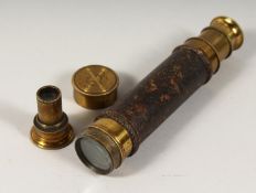 A SMALL BRASS AND LEATHER TELESCOPE 15.5ins long open.