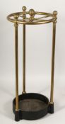 A BRASS STICK STAND on iron base 22ins high