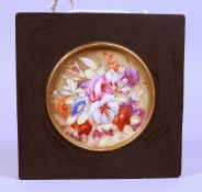 AN ENGLISH PORCELAIN FLOWER PLAQUE. 5.5ins diameter.