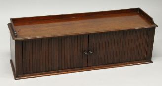 A LONG MAHOGANY TAMBOUR CABINET. 3ft 5ins long 11ins deep, 1ft 2ins high.