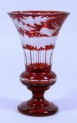 A BOHEMIAN RUBY THISTLE SHAPED VASE engraved with deer. 8.5ins high.