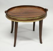 A GEORGIAN MAHOGANY OVAL TWO HANDLED TEA TRAY with brass banding, on a later stand with curving