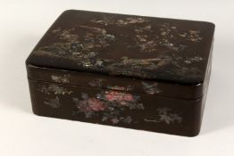 A CHINESE BLACK LACQUER AND MOTHER OF PEARL BOX inset with birds and almond blossom. 16ins long,