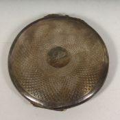 AN ENGINE TURNED SILVER COMPACT Birmingham 1934, 2.75ins diameter.
